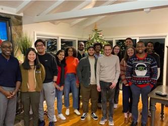 Hervey-Jumper lab standing in front of a Christmas tree